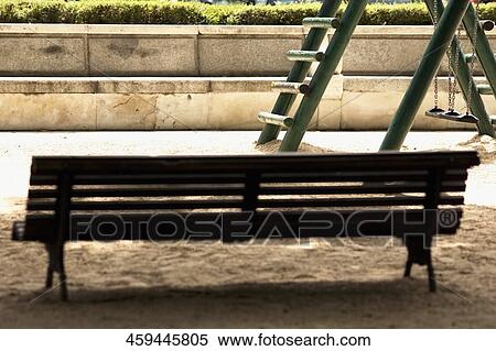 Stock Photography - Empty bench in a park, Madrid, Spain. Fotosearch