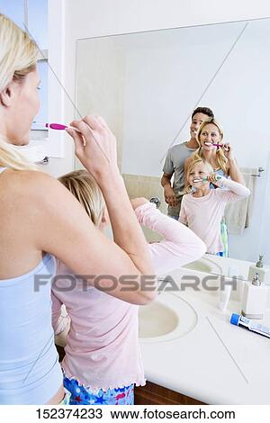 Family brushing teeth in the bathroom View Large Photo Image Stock Image - Family brushing teeth in the bathroom. Fotosearch
