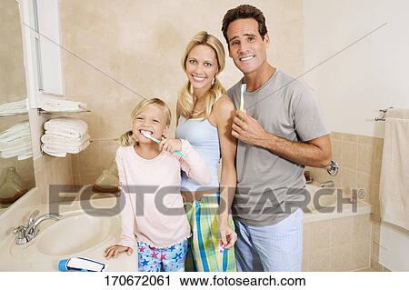 Stock Image - Family brushing teeth in the bathroom. Fotosearch