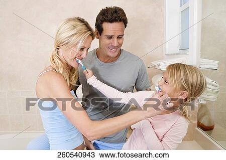Family brushing teeth in the bathroom View Large Photo Image Stock Image - Family brushing teeth in the bathroom. Fotosearch