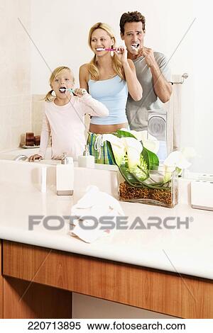 Family brushing teeth in the bathroom View Large Photo Image Stock Photography - Family brushing teeth in the bathroom. Fotosearch
