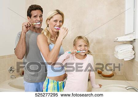 Family brushing teeth in the bathroom View Large Photo Image Stock Photography - Family brushing teeth in the bathroom. Fotosearch