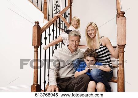 Stock Photography - Family sitting on a staircase. Fotosearch