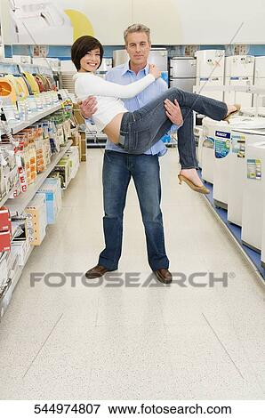 Father carrying his daughter in a supermarket View Large Photo Image Stock Photo - Father carrying his daughter in a supermarket. Fotosearch