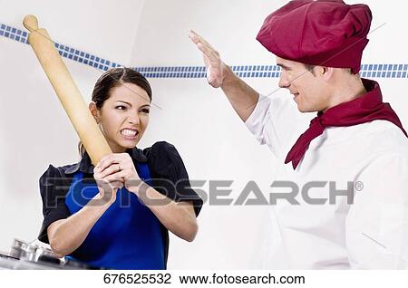 Female and a male chef fighting in the kitchen View Large Photo Image Stock Image - Female and a male chef fighting in the kitchen. Fotosearch