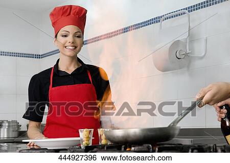 Female chef cooking food in the kitchen View Large Photo Image Stock Photograph - Female chef cooking food in the kitchen. Fotosearch