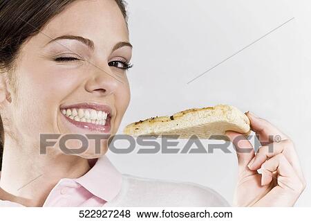 Female chef eating a pizza and winking View Large Photo Image Stock Photo - Female chef eating a pizza and winking. Fotosearch
