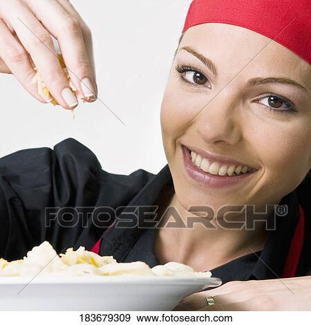 Female chef garnishing food View Large Photo Image Stock Photo - Female chef garnishing food. Fotosearch
