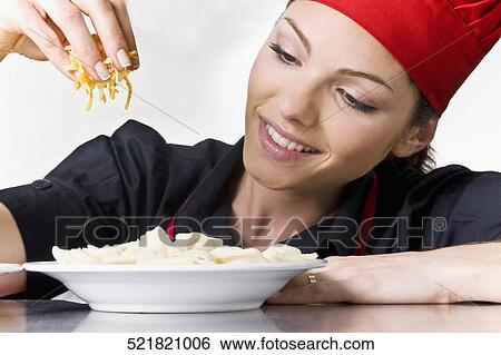 Female chef garnishing food View Large Photo Image Stock Photograph - Female chef garnishing food. Fotosearch