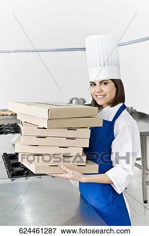 Female chef holding stack of pizza boxes and smiling View Large Photo Image Stock Photo - Female chef holding stack of pizza boxes and smiling. Fotosearch