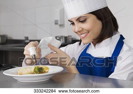 Female chef icing pastries View Large Photo Image Picture - Female chef icing pastries. Fotosearch