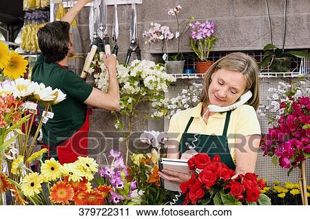 Female florist talking on the phone View Large Photo Image Stock Image - Female florist talking on the phone. Fotosearch