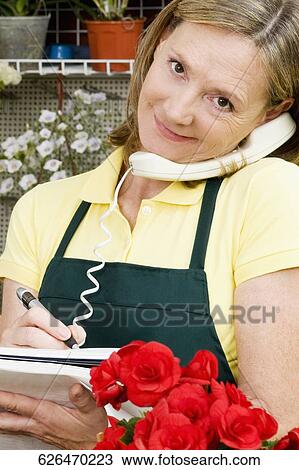 Female florist talking on the phone View Large Photo Image Stock Image - Female florist talking on the phone. Fotosearch
