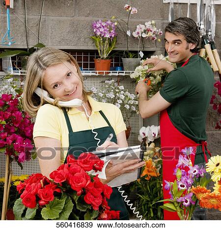 Stock Photo - Female florist talking on the phone. Fotosearch