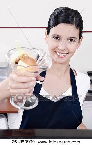 Female ice cream seller holding a glass of ice cream View Large Photo Image Stock Photo - Female ice cream seller holding a glass of ice cream. Fotosearch