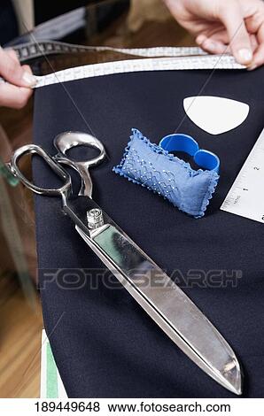 Female tailor taking measurement in a clothing store View Large Photo Image Stock Photo - Female tailor taking measurement in a clothing store. Fotosearch