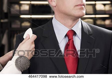 Female tailor taking measurement of a businessman View Large Photo Image Stock Photo - Female tailor taking measurement of a businessman. Fotosearch