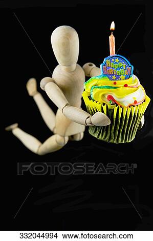 Figurine carrying a birthday cake View Large Photo Image Picture - Figurine carrying a birthday cake. Fotosearch