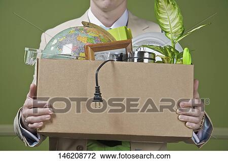Fired businessman holding his office belongings View Large Photo Image Stock Image - Fired businessman holding his office belongings. Fotosearch