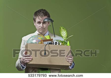 Fired businessman holding his office belongings View Large Photo Image Stock Image - Fired businessman holding his office belongings. Fotosearch