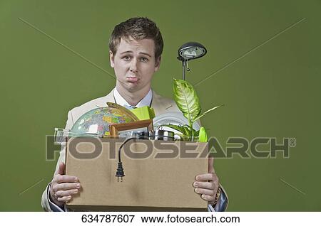 Stock Photo - Fired businessman holding his office belongings. Fotosearch