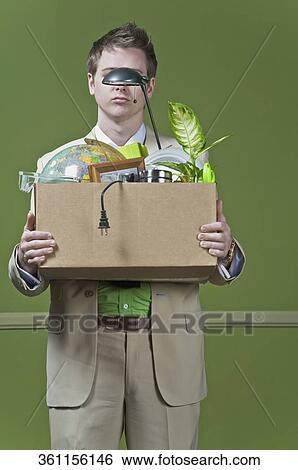 Fired businessman holding his office belongings View Large Photo Image Stock Photograph - Fired businessman holding his office belongings. Fotosearch