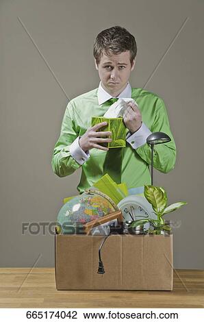 Stock Image - Fired businessman picking a tissue paper. Fotosearch