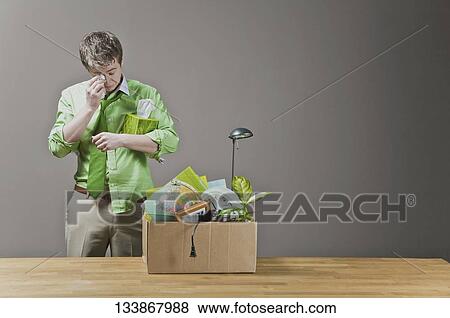 Fired businessman wiping his tears View Large Photo Image Stock Photo - Fired businessman wiping his tears. Fotosearch