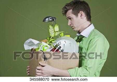 Stock Image - Fired businessman with his office belongings. Fotosearch