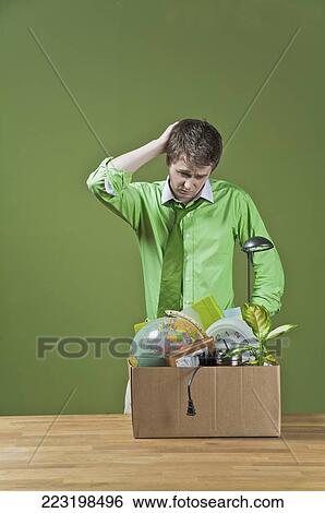 Stock Photograph - Fired businessman with his office belongings. Fotosearch