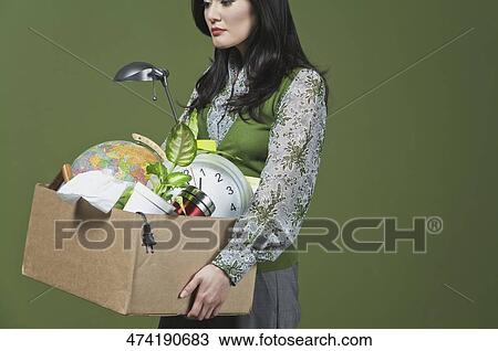 Fired businesswoman carrying her belongings in a cardboard box View Large Photo Image Stock Image - Fired businesswoman carrying her belongings in a cardboard box. Fotosearch