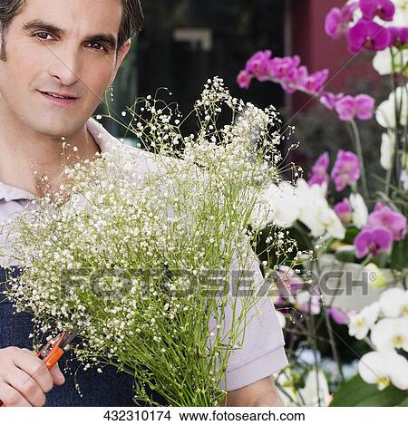 Picture - Florist making a bouquet of flowers. Fotosearch