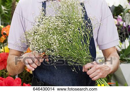 Florist making a bouquet of flowers View Large Photo Image Picture - Florist making a bouquet of flowers. Fotosearch
