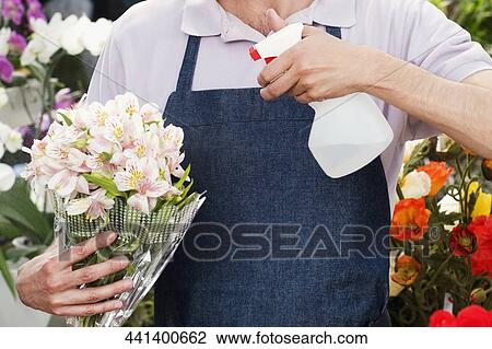 Stock Image - Florist making a bouquet of flowers. Fotosearch