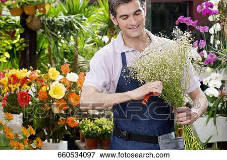 Florist making a bouquet of flowers View Large Photo Image Stock Photo - Florist making a bouquet of flowers. Fotosearch