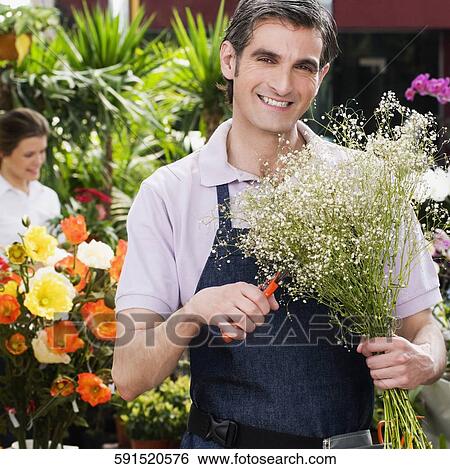 Florist making a bouquet of flowers View Large Photo Image Stock Photograph - Florist making a bouquet of flowers. Fotosearch