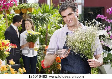 Florist pruning flowers View Large Photo Image Stock Image - Florist pruning flowers. Fotosearch