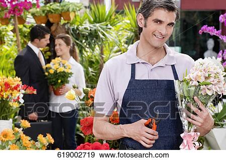 Florist pruning flowers View Large Photo Image Stock Photo - Florist pruning flowers. Fotosearch