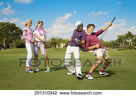 Four friends having fun in a golf course, Biltmore Golf Course, Coral Gables, Florida, USA View Large Photo Image Stock Image - Four friends having fun in a golf course, Biltmore Golf Course, Coral Gables, Florida, USA. Fotosearch