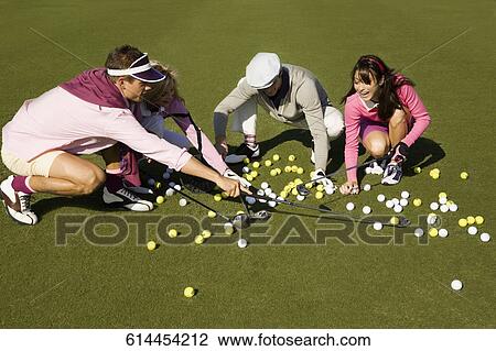 Stock Image - Four friends playing golf, Biltmore Golf Course, Coral Gables, Florida, USA. Fotosearch