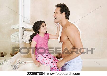 Picture - Girl applying shaving foam on her father's face. Fotosearch