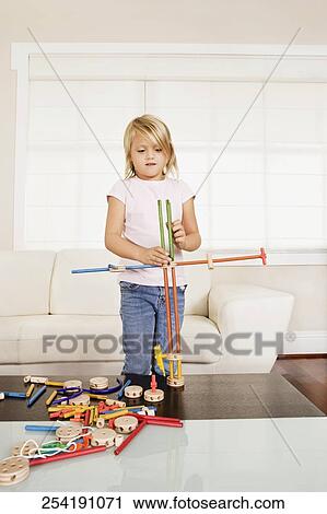 Girl assembling a toy View Large Photo Image Stock Image - Girl assembling a toy. Fotosearch