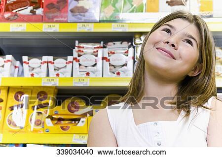 Girl day dreaming in a supermarket View Large Photo Image Stock Image - Girl day dreaming in a supermarket. Fotosearch