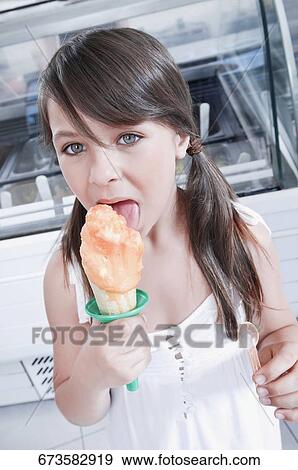Girl eating an ice cream View Large Photo Image Stock Photo - Girl eating an ice cream. Fotosearch