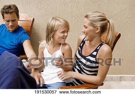 Girl having fun with her parents View Large Photo Image Stock Photo - Girl having fun with her parents. Fotosearch