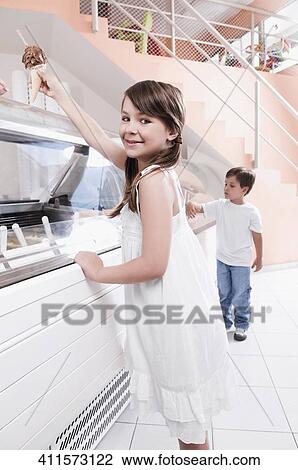 Stock Image - Girl holding an ice cream. Fotosearch
