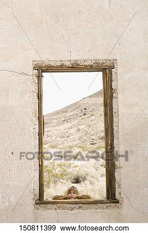 Girl looking through a window View Large Photo Image Stock Photo - Girl looking through a window. Fotosearch