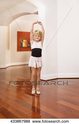 Girl practicing ballet in a house View Large Photo Image Stock Photo - Girl practicing ballet in a house. Fotosearch