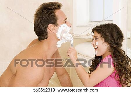 Girl shaving her father in the bathroom View Large Photo Image Stock Photo - Girl shaving her father in the bathroom. Fotosearch