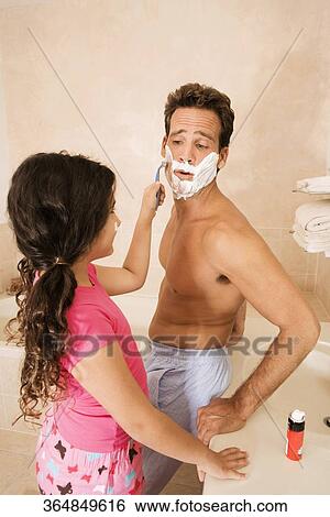 Girl shaving her father in the bathroom View Large Photo Image Stock Photograph - Girl shaving her father in the bathroom. Fotosearch